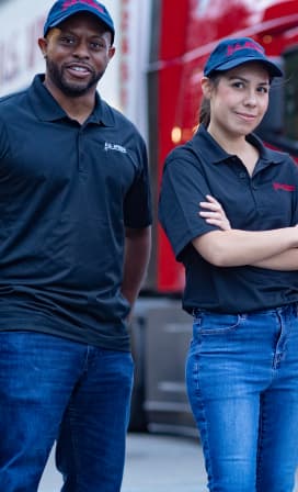 An African-American male driver and white female driver with black U.S. Xpress shirts.